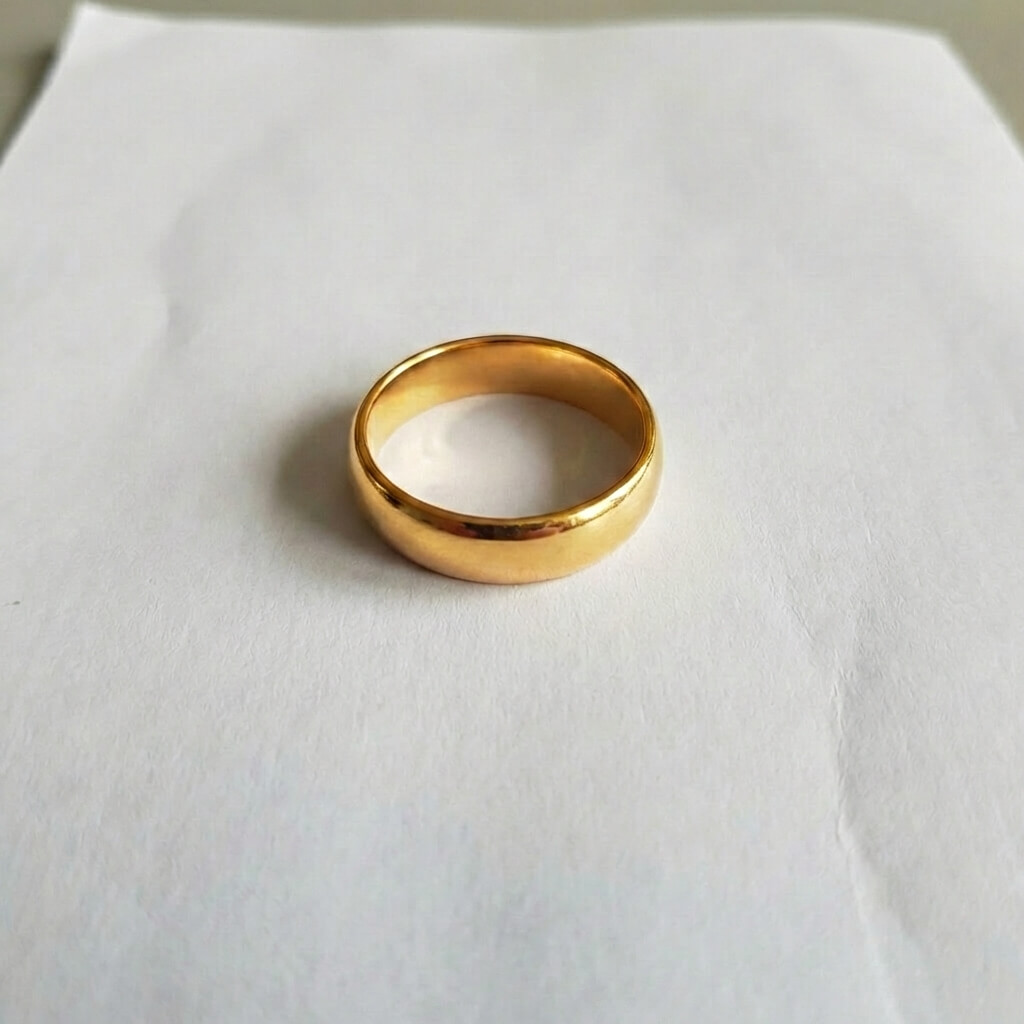 Raw unedited gold ring photo with dark reflections and dull lighting