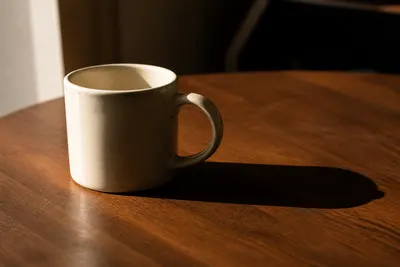 Product photo before using the AI Shadow Remover, with a hard cast shadow on the table