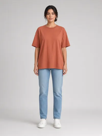 Model wearing a terracotta oversized t-shirt and jeans
