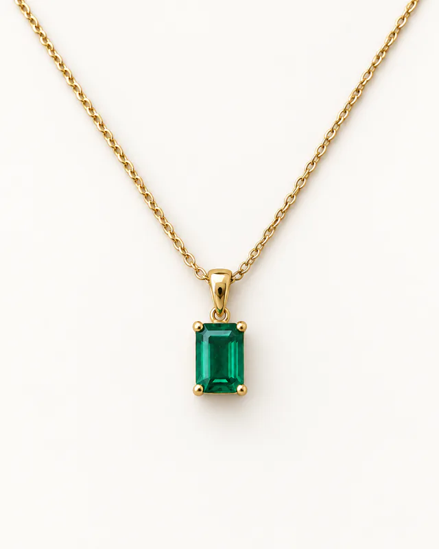 The emerald pendant necklace presented on a clean white studio background